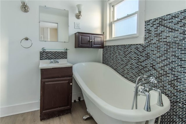 bathroom with hardwood / wood-style floors, vanity, and a bathtub