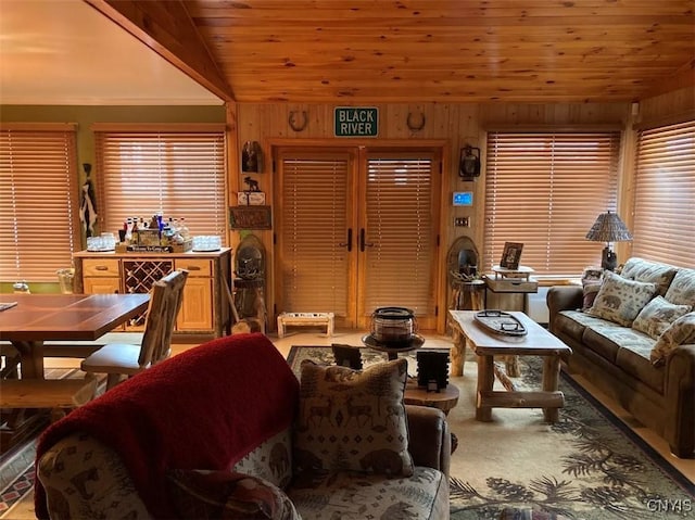 carpeted living room with lofted ceiling, wooden ceiling, and wooden walls