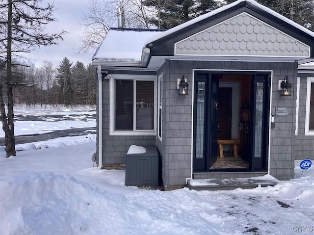 view of snow covered property entrance