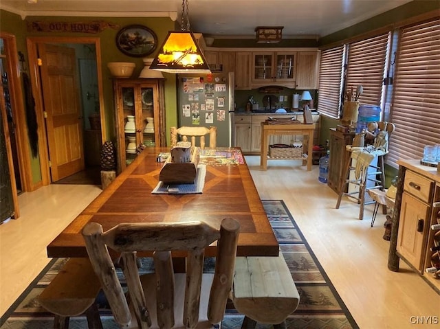 dining room featuring crown molding and light wood-type flooring