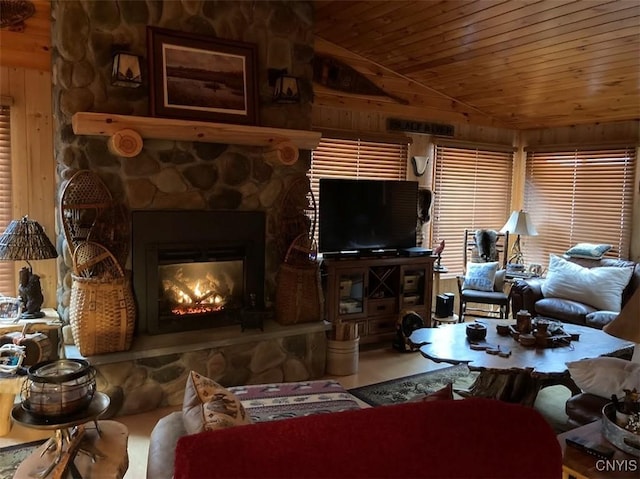 living room featuring wood walls, wooden ceiling, a fireplace, and vaulted ceiling