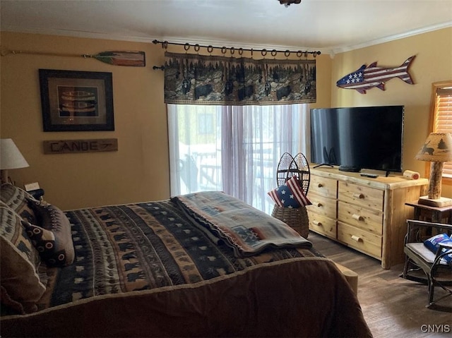 bedroom with dark hardwood / wood-style floors and ornamental molding