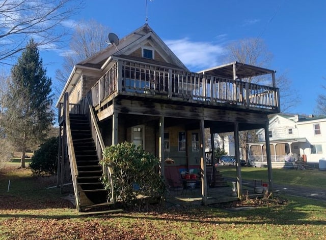 rear view of property featuring a deck and a lawn