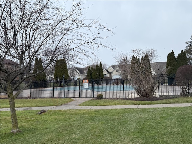 view of pool with a yard