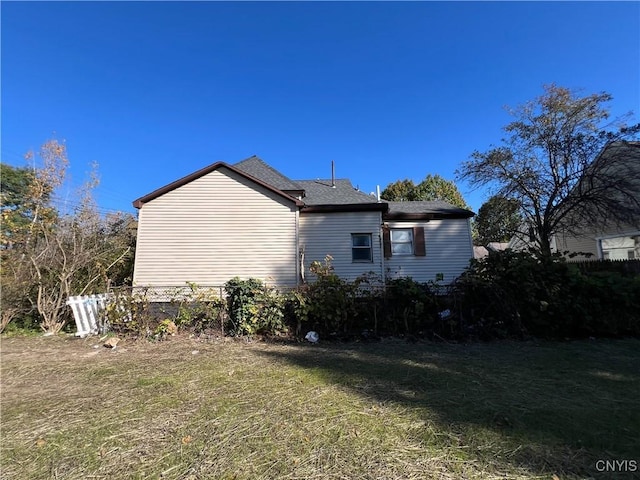 view of property exterior featuring a lawn