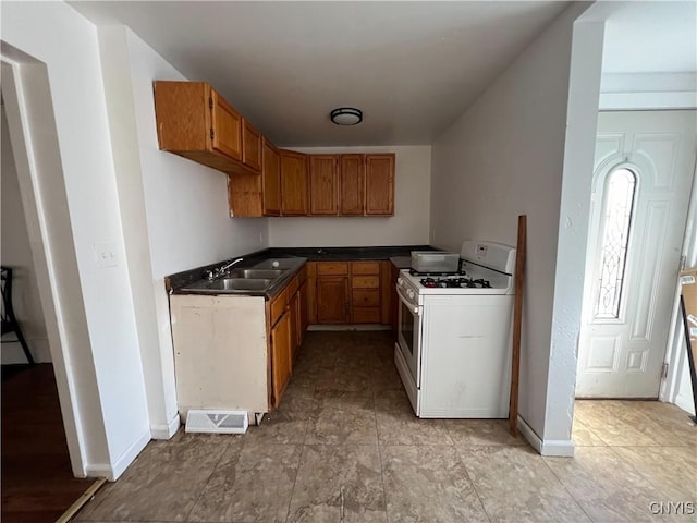 kitchen featuring sink and white gas range oven