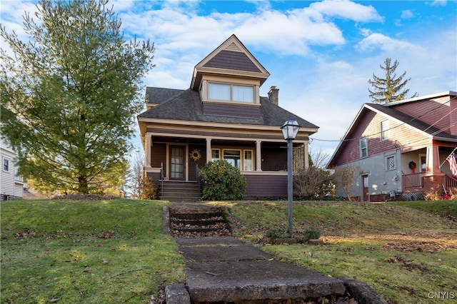 view of front of house with a front lawn and a porch