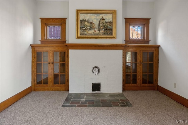 unfurnished living room featuring french doors and dark colored carpet