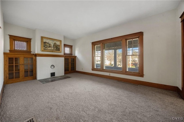 unfurnished living room featuring carpet flooring