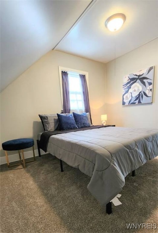 carpeted bedroom with vaulted ceiling