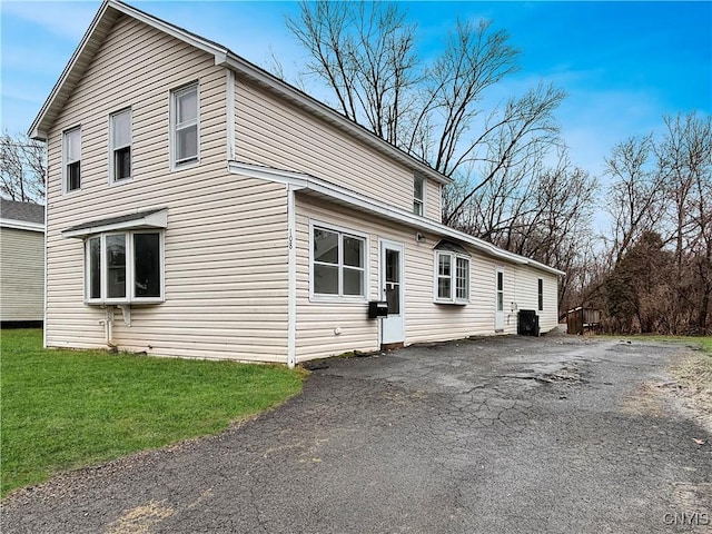 view of side of home with a lawn