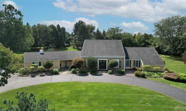 cape cod house with a front lawn