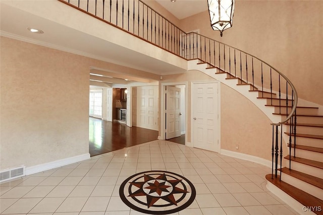 tiled foyer with crown molding