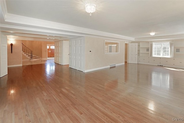 spare room featuring hardwood / wood-style flooring, a chandelier, and ornamental molding