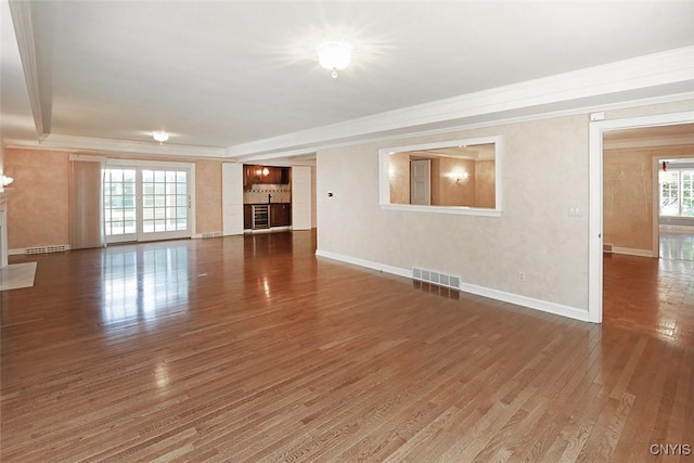 unfurnished living room with plenty of natural light and dark wood-type flooring