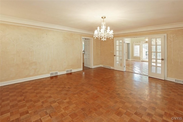 spare room featuring a notable chandelier, crown molding, baseboard heating, parquet flooring, and french doors