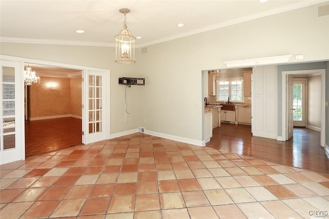 unfurnished dining area with crown molding, light tile patterned flooring, a notable chandelier, and french doors