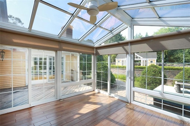 unfurnished sunroom featuring ceiling fan and vaulted ceiling