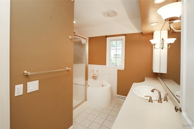 bathroom with a bath, vanity, and tile patterned flooring