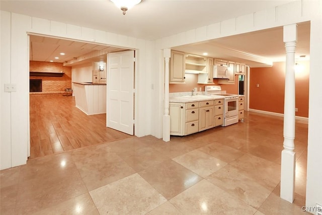 kitchen featuring sink, cream cabinets, and white appliances