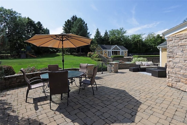 view of patio featuring a playground and an outdoor hangout area