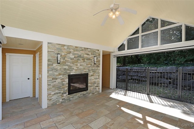 unfurnished living room featuring high vaulted ceiling, a healthy amount of sunlight, and a fireplace