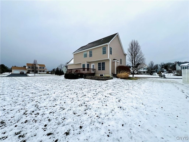 snow covered house with a deck