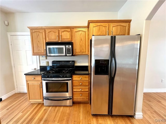 kitchen with light wood-type flooring and stainless steel appliances