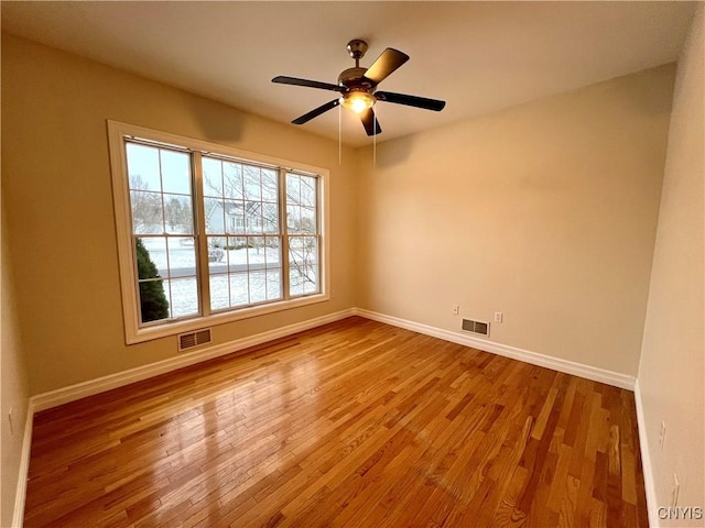 spare room featuring ceiling fan and light wood-type flooring