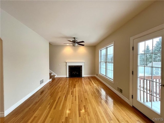 unfurnished living room with ceiling fan and light wood-type flooring