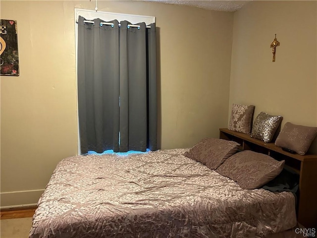 bedroom with hardwood / wood-style floors and a textured ceiling