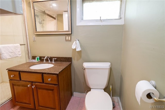 bathroom with vanity, an enclosed shower, and toilet