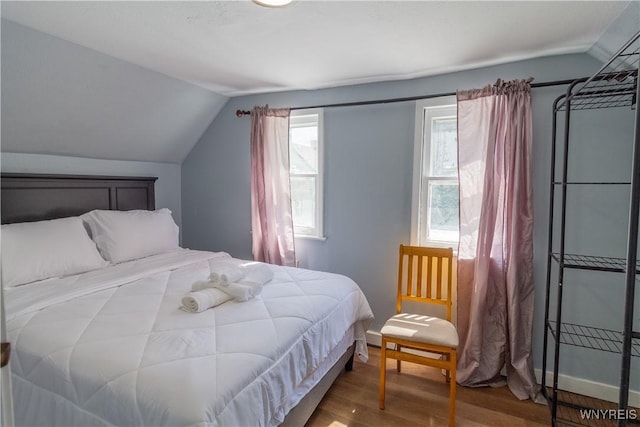 bedroom featuring lofted ceiling and wood-type flooring