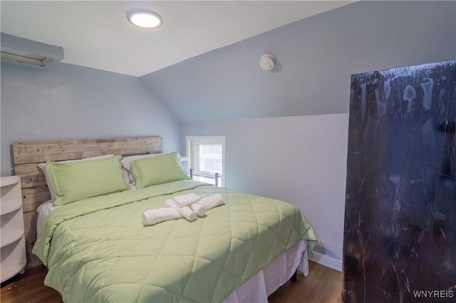 bedroom featuring vaulted ceiling and dark hardwood / wood-style floors