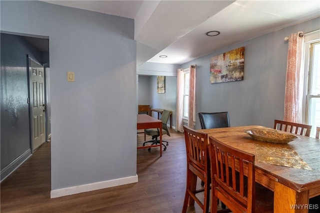 dining space with dark hardwood / wood-style flooring