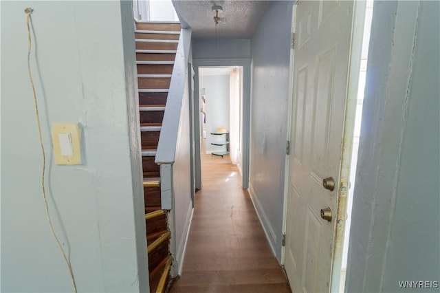 hallway with a textured ceiling