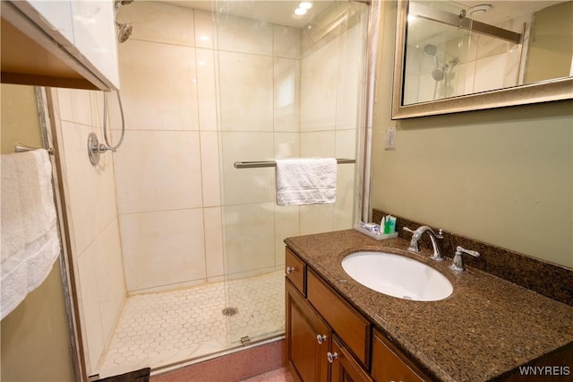 bathroom featuring vanity and a shower with shower door