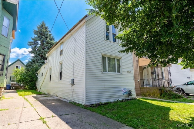 view of side of home featuring a yard