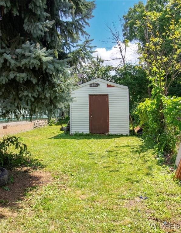 view of outbuilding featuring a yard