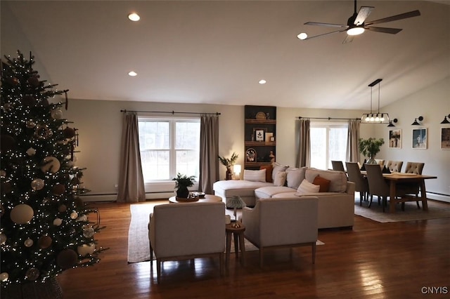 living room featuring a healthy amount of sunlight, ceiling fan, dark wood-type flooring, and lofted ceiling