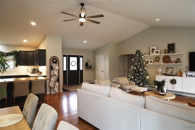 living room featuring ceiling fan, dark wood-type flooring, and lofted ceiling