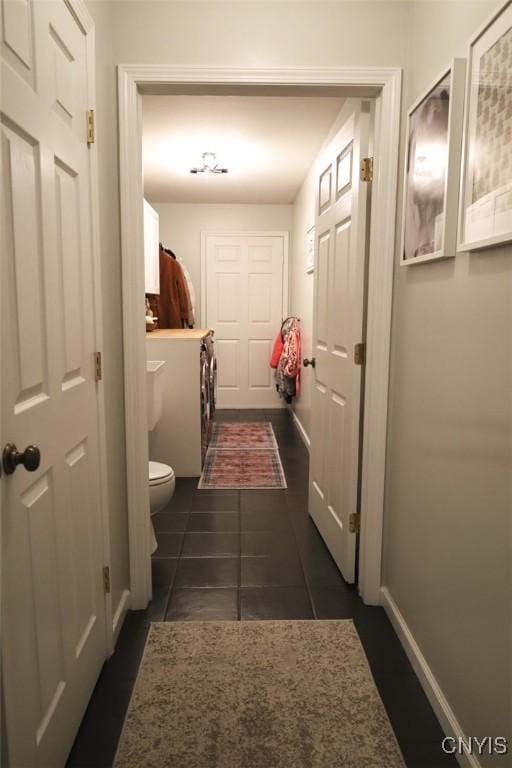 hall with dark tile patterned floors