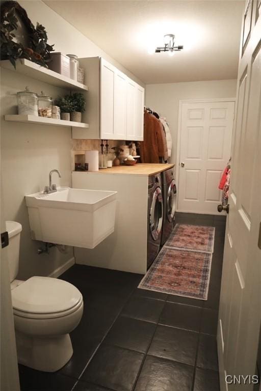 laundry room with washing machine and dryer and sink