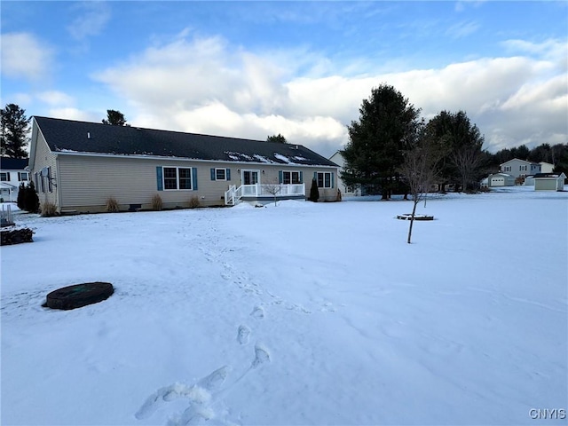 view of snow covered rear of property