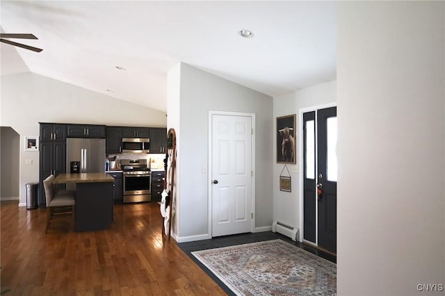 foyer featuring dark wood-type flooring, vaulted ceiling, ceiling fan, and a baseboard heating unit