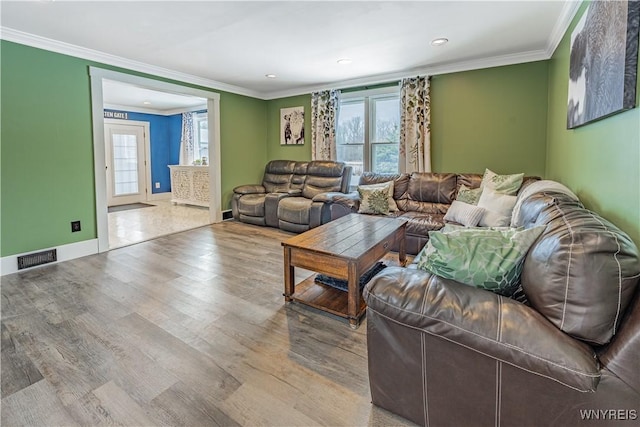 living room featuring light hardwood / wood-style floors and ornamental molding