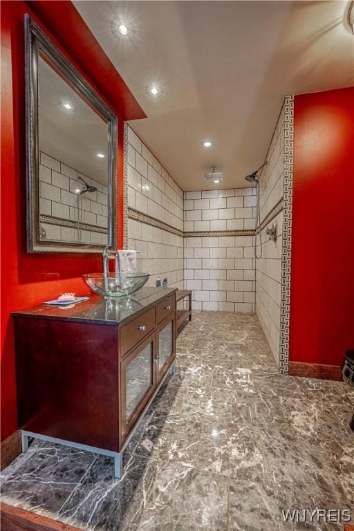 bathroom featuring vanity and tiled shower