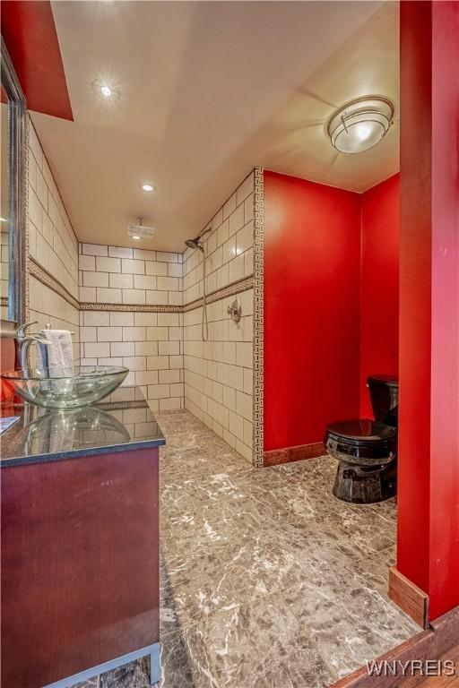 bathroom with vanity and a shower