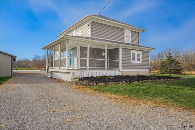 view of front facade featuring covered porch and a front yard