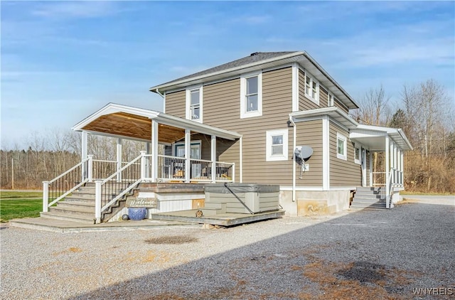 view of front of home with a hot tub and a porch